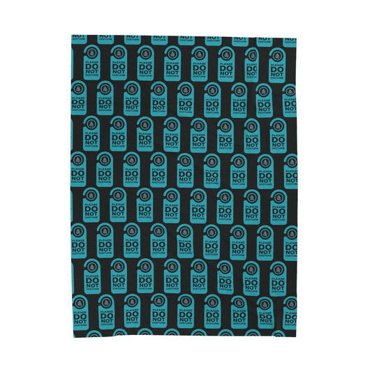 Black blanket with a repeated image of a door do not disturb tag with text 'Please do not disturb' in green and the OYFT logo where the door knob would be. 