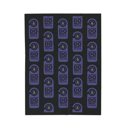 Black blanket with a repeated image of a door do not disturb tag with text 'Please do not disturb' in purple and the OYFT logo where the door knob would be. 