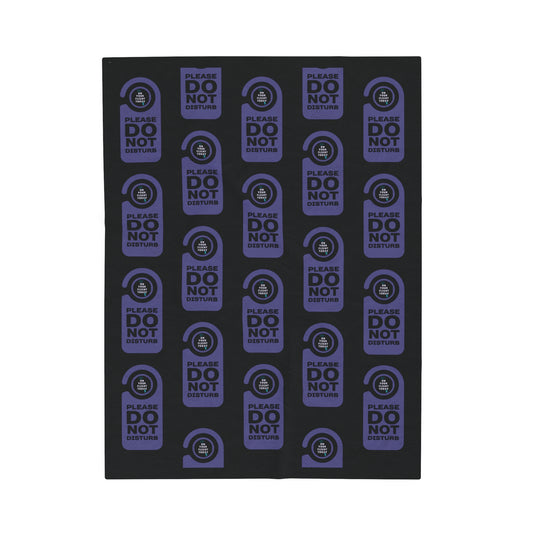 Black blanket with a repeated image of a door do not disturb tag with text 'Please do not disturb' in purple and the OYFT logo where the door knob would be. 